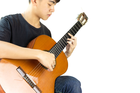 Asian man playing a classic guitar isolatedの写真素材
