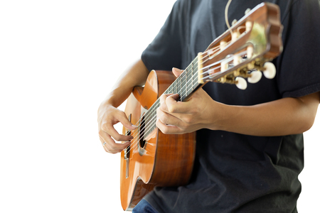Asian man playing a classic guitar isolatedの写真素材