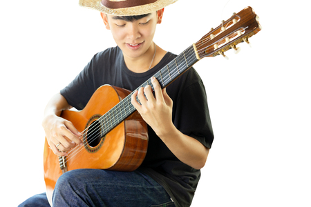 Asian man playing a classic guitar isolated in whiteの写真素材