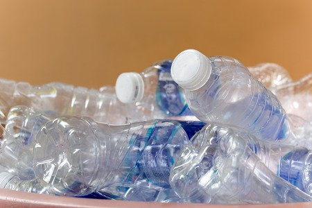 Recyclable garbage of glass plastic bottles in rubbish bin.の写真素材