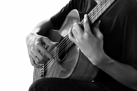 Man playing classic guitar isolated on black and white in clipping path.の写真素材