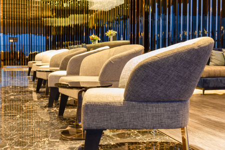 Interior room with row of modern armchairs on marble floor.の写真素材
