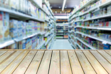 Wooden board with empty table blurred shopping mallの写真素材