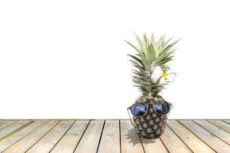 Funny pineapple with sunglasses and flower isolated on whiteの写真素材