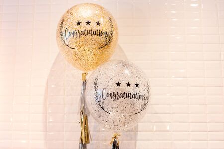 Word congratulation on balloons white tile wallの写真素材