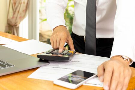Businessman working on calculator to calculate financial plan.の写真素材