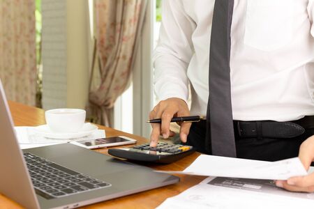 Businessman working on calculator to calculate financial plan.の写真素材
