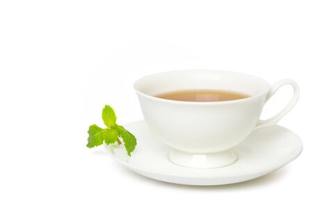 Tea in white cup with leaf mint isolated on whiteの写真素材