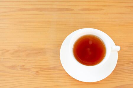 Top view cup of tea on wooden table.の写真素材