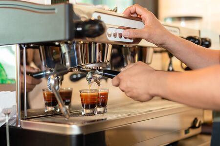 Barista preparing coffee Espresso shot from machine brewing coffee.の写真素材