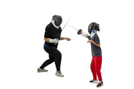 Young boy leaning fencing with mask and sabre isolated in white background.の写真素材