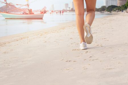 Female exercise walking on the beach in the morning.の写真素材