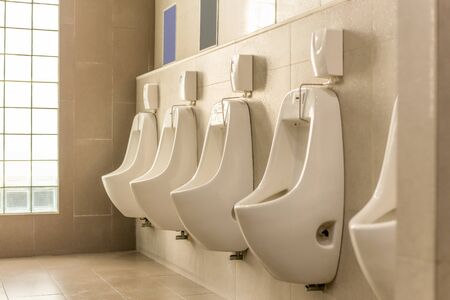 White urinals in a row in men public toilet.の写真素材