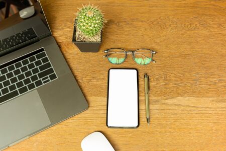 Top view of office desk with laptop, eyeglasses, pen and computer mouses.の写真素材