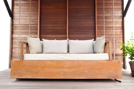 Outdoor porch swing wooden chair with cushion on the terrace with wooden floor.の写真素材