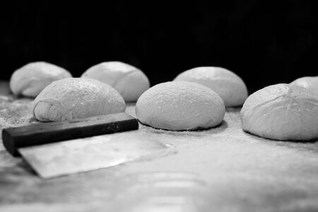 Ball of pizza dough on table with dusting of flour.の写真素材