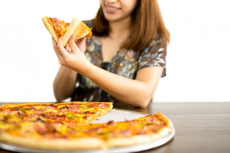 Happy woman holding pizza slices in hands isolated in white backgroundの写真素材