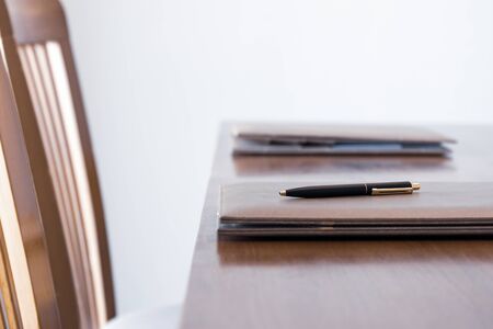 Leather folder with pen on the meeting desk business conceptの写真素材
