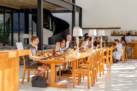 25 Nov 2019 - Group of multiethnic tourist working on laptop on vacation at Home Chiang Mai Hotel Thailand.のeditorial素材