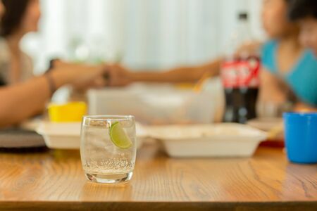 Healthy nutrition of drinking water with slice lime on lunch table.の写真素材
