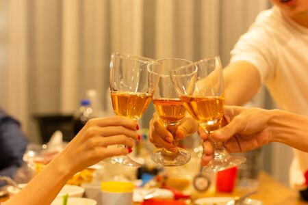 Grpup of friend toasting with glass of white at dinner party.の写真素材