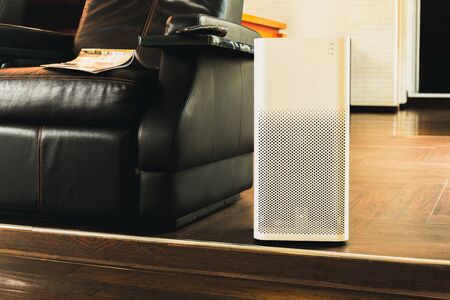 Electric air purifier in a living room for cleaning fine dust in house.