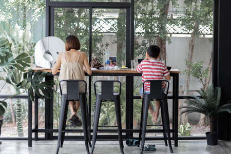 Mother and son having lunch together at cafe.