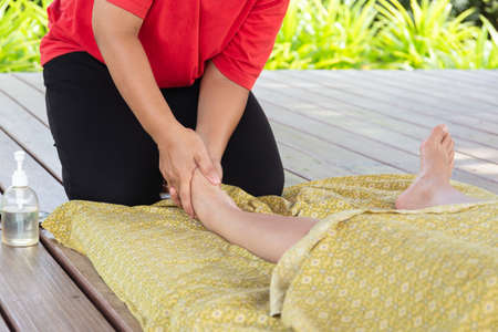 Woman relax having foot massage outdoor on vacation.の写真素材