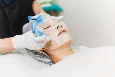 Woman having stimulating facial treatment at professional clinic.の写真素材