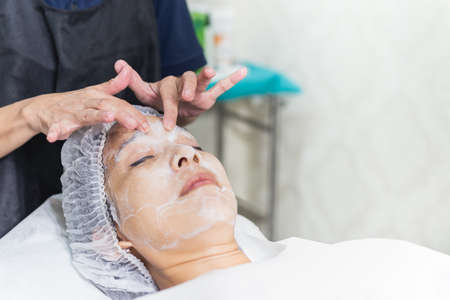 Woman getting spa massage treatment at beauty spa salon.の写真素材