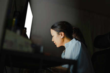 Businesswoman working on the computer late at night.の写真素材