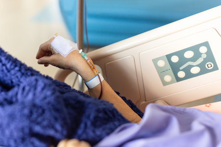 Old woman patients hand have a blood transfusion in the hospital.の写真素材
