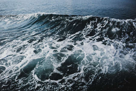 Blue sea water with white wave for background.の写真素材