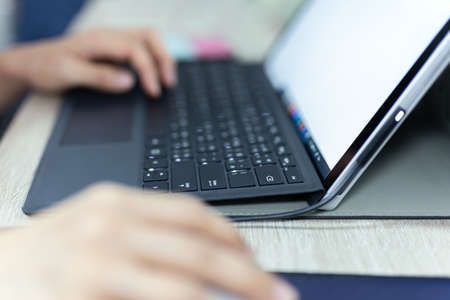 Close up of business woman hand typing on laptop keyboard work at home.の写真素材