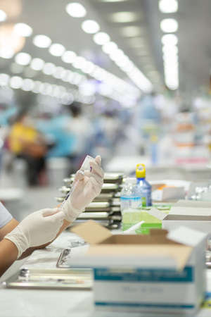 Nurse wearing medical mask preparing  virus vaccine to vaccinate.の写真素材