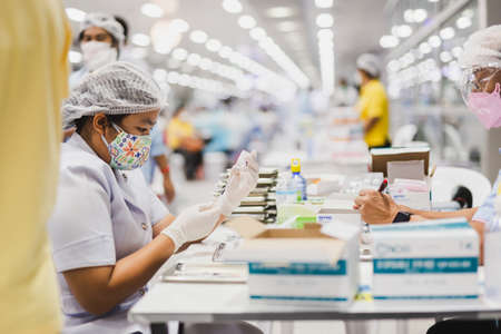 June 7th, 2021- At Bang Sue Grand Station Bangkok Thailand : Health worker holds syringe and bottle of vaccine for coronavirus cure.のeditorial素材