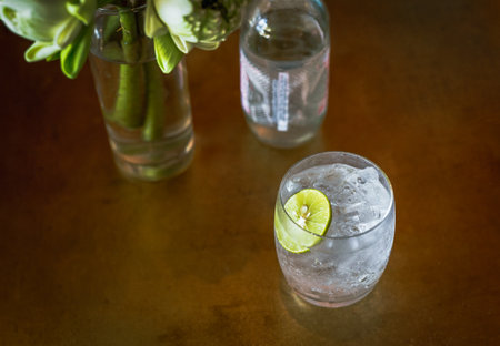 Top view glass or fresh sparkling mineral water with slice of lime.の写真素材