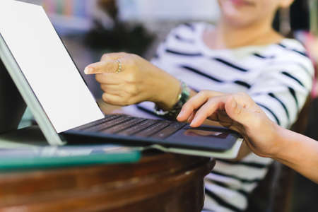Businesswomen teamwork sitting by desk using computer laptop discussing in office.の写真素材