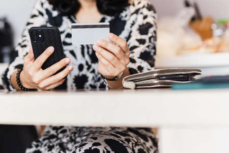 Woman holding cell phone and credit card, Online shopping concept.の写真素材