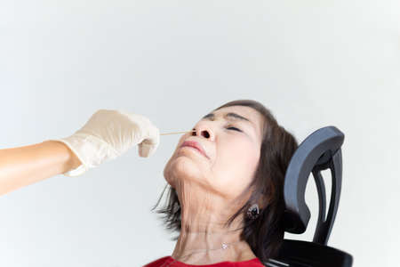 Elderly woman having her nasal swab