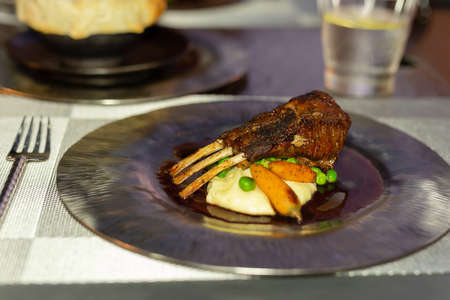 Rack of lamb served with mashed potatoes and lamb sauce.