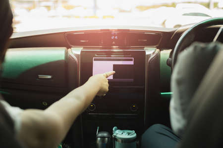 Woman touch screen display in a car for direction.の写真素材