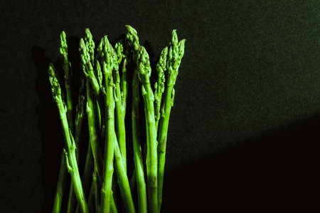 Green fresh asparagus isolated on black background.の写真素材