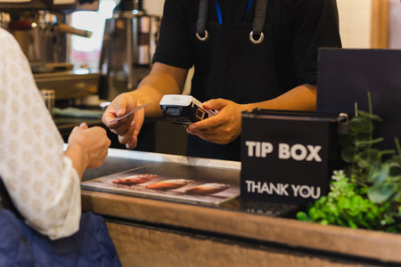 Asia woman use cashless wifi paywave scan on card reader in coffee shop.の写真素材