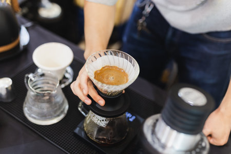 Top view of barista brewing of coffee in paper filter.の写真素材