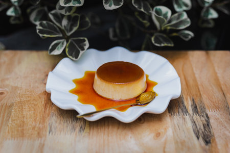 White plate of delicious caramel custrad on wooden table.の写真素材
