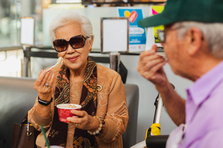 Happy senior couple enjoy eating ice cream.