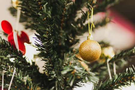 Close up of golden ball decorating on christmas tree.の写真素材