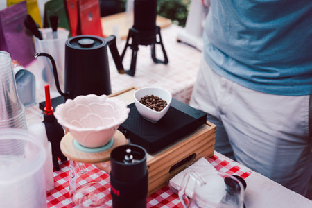 Barista weigh out the coffee beans on digital scales.