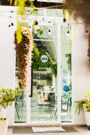 Open sign broad hang on entrance door at coffee shop in vertical.の写真素材